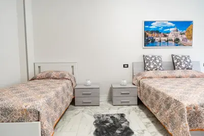 a bedroom with two beds and a cat sitting between them at locazione turistica via dei savorelli 120 in Rome