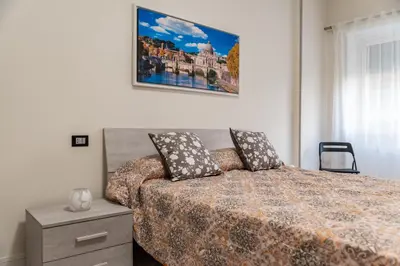 a bedroom with a bed and a picture on the wall at locazione turistica via dei savorelli 120 in Rome