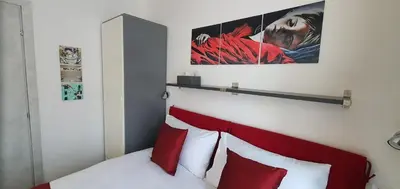 a bedroom with a bed with red and white pillows at Vatican Apartment St. Peter in Rome
