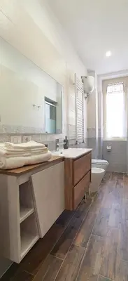 a bathroom with a sink and a tub and a mirror at Vatican Apartment St. Peter in Rome