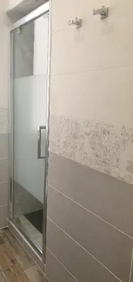 a shower with a glass door in a bathroom at Vatican Apartment St. Peter in Rome