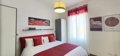 a bedroom with a red and white bed and a window at Vatican Apartment St. Peter in Rome