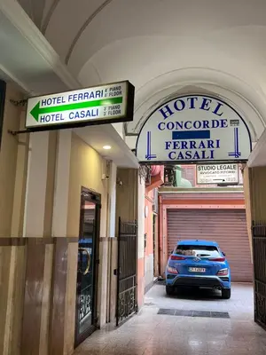 a hotel room with two beds and a plant at Hotel Casali in Rome