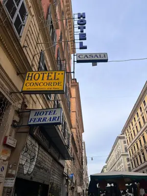 a hotel room with two beds and yellow walls at Hotel Casali in Rome