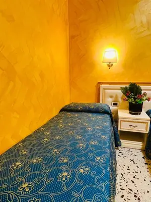 a hotel room with a bed and a picture on the wall at Hotel Casali in Rome