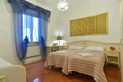 a bedroom with two beds and a window at Gisa Rooms in Rome