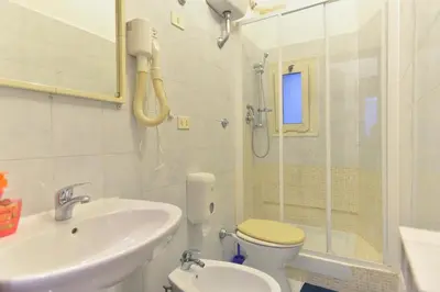 a bathroom with a sink and a toilet and a shower at Gisa Rooms in Rome