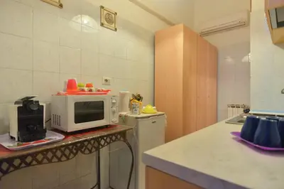 a small kitchen with a microwave on a counter at Gisa Rooms in Rome