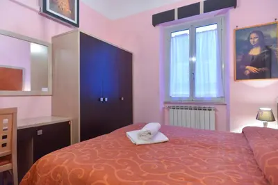 a bedroom with a bed with a white towel on it at Gisa Rooms in Rome