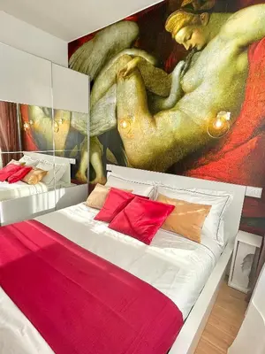a bedroom with a painting on the wall at E&E Guest House in Rome