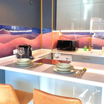 a kitchen with a table with plates and wine glasses at E&E Guest House in Rome