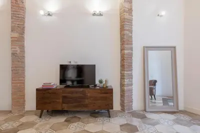 a living room with a television and a mirror at iFlat Trastevere Unique Loft in Rome