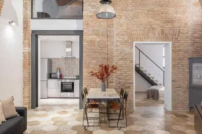 a dining room with a table and a brick wall at iFlat Trastevere Unique Loft in Rome