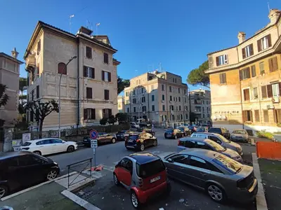 a group of cars parked in a parking lot at Lotto 30 Metro Garbatella in Rome
