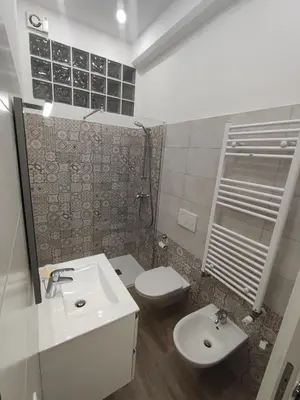 a bathroom with a sink and a toilet at Lotto 30 Metro Garbatella in Rome
