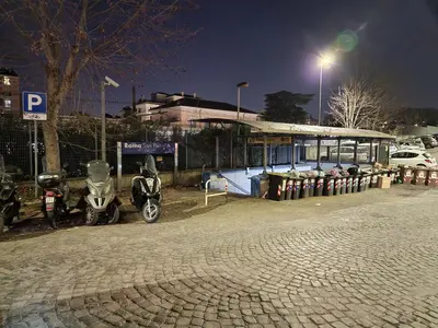 two motorcycles parked in front of a gas station at night at Giuditta San Pietro 52 Loft Roma in Rome