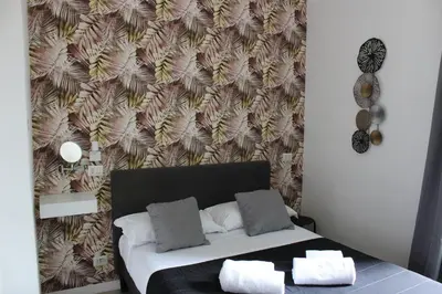 a bed in a room with a wall at Rooms Piramide in Rome