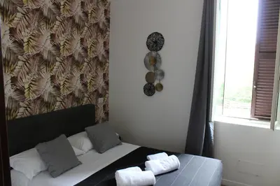 a bedroom with a bed with towels on it at Rooms Piramide in Rome