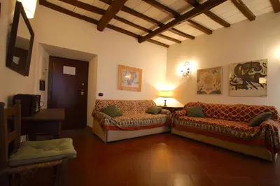 a living room with two couches and a table at Pozzuolo Holiday House in Rome