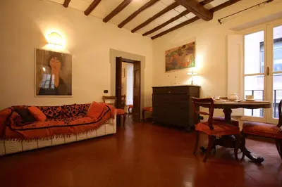 a living room with a bed and a table at Pozzuolo Holiday House in Rome