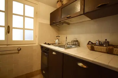 a kitchen with a sink and a counter top at Pozzuolo Holiday House in Rome