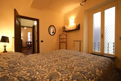 a bedroom with a large bed and a window at Pozzuolo Holiday House in Rome