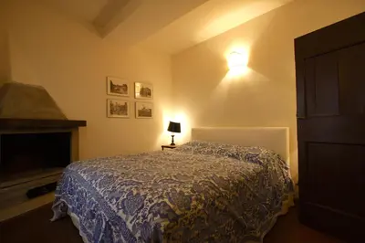 a bedroom with a bed and a lamp on a table at Pozzuolo Holiday House in Rome