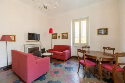 a living room with a table and chairs and a fireplace at CHARMING APARTMENT AT SPANISH STEPS, no elevator in Rome