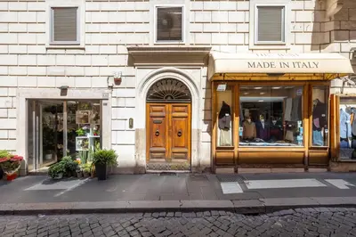 a store with a wooden door in a building at CHARMING APARTMENT AT SPANISH STEPS, no elevator in Rome