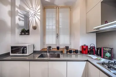 a kitchen with a sink and a microwave at PgrHome Borgo Vittorio in Rome