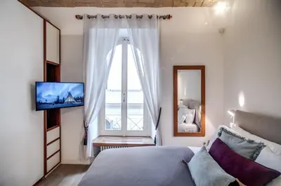 a bedroom with a bed and a large window at PgrHome Borgo Vittorio in Rome
