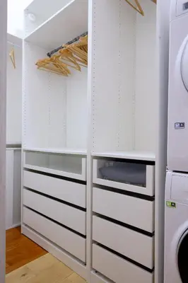 a kitchen with white cabinets and a refrigerator at Testaccio Guest House in Rome