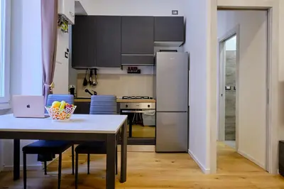 a kitchen with a table and a refrigerator at Testaccio Guest House in Rome