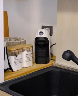a toaster sitting on a shelf next to a kitchen sink at Testaccio Guest House in Rome