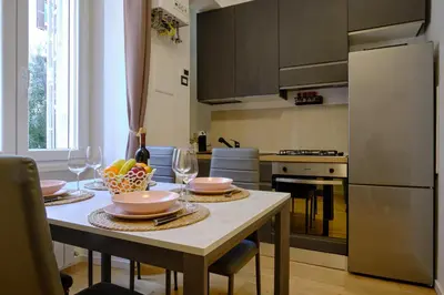 a kitchen with a table with plates and wine glasses at Testaccio Guest House in Rome