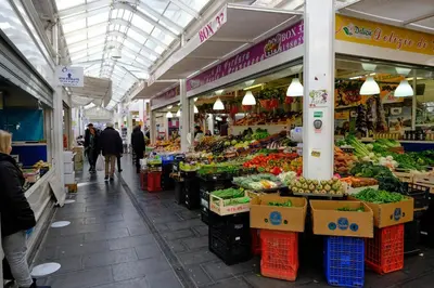 a market with people walking through a market with fruits and vegetables at Testaccio Guest House in Rome