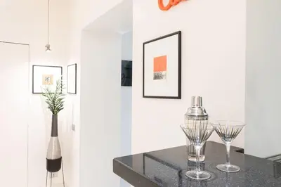 a dining room with two wine glasses on a table at Manara 57 Dream Apartment Trastevere in Rome