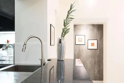 a kitchen with a sink and a vase on a counter at Manara 57 Dream Apartment Trastevere in Rome