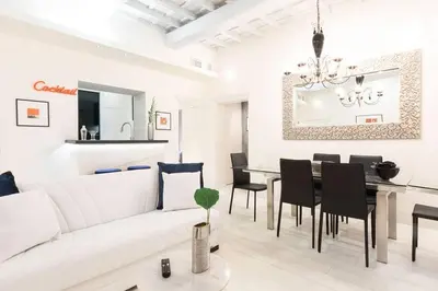a living room with a white couch and a table at Manara 57 Dream Apartment Trastevere in Rome