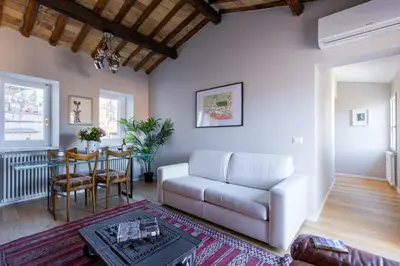 a living room with a white couch and a table at Rome As You Feel - Luxury Terrace in Navona in Rome