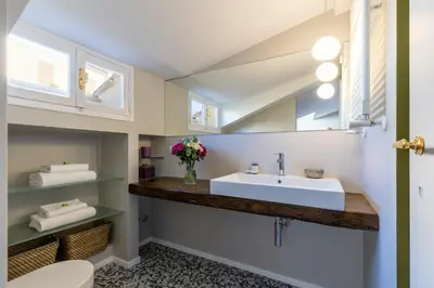 a bathroom with a sink and a mirror at Rome As You Feel - Luxury Terrace in Navona in Rome