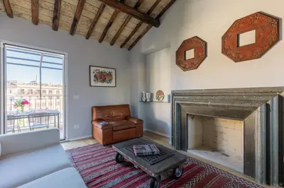 a living room with a couch and a fireplace at Rome As You Feel - Luxury Terrace in Navona in Rome