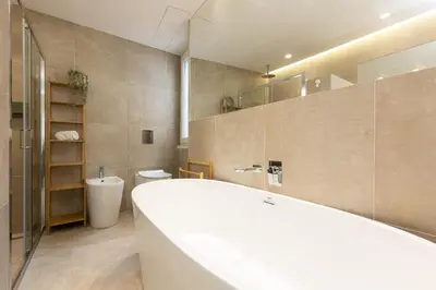 a bathroom with a tub and a toilet and a sink at AURELIA SUNSET PENTHOUSE by Rental in Rome in Rome