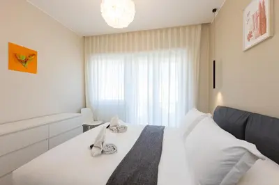 a bedroom with a white bed and a window at AURELIA SUNSET PENTHOUSE by Rental in Rome in Rome