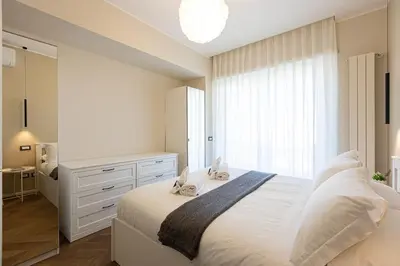 a bedroom with a white bed and a window at AURELIA SUNSET PENTHOUSE by Rental in Rome in Rome
