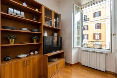 a living room with a tv and a large window at SAINT PETER HOME by Rental in Rome in Rome