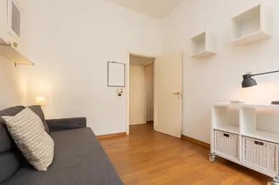 a living room with a couch and a hallway at SAINT PETER HOME by Rental in Rome in Rome