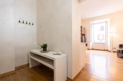 a white desk in a white room with a table at SAINT PETER HOME by Rental in Rome in Rome