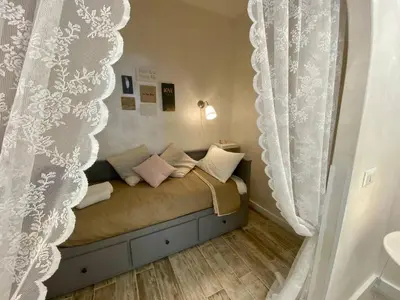a heart pillow sitting on a chair next to a table at Apartment near the Colosseum, with metro line A a 2 minutes walk away in Rome