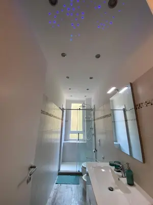 a bathroom with a sink and a mirror at Apartment near the Colosseum, with metro line A a 2 minutes walk away in Rome